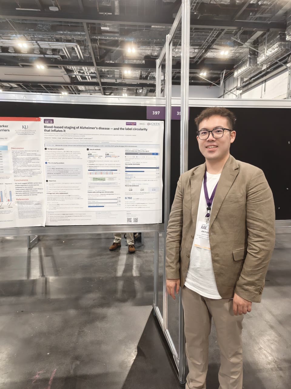 Jiayuan Xu beside his blood-based Alzheimer’s disease staging poster at AAIC 2026 in London